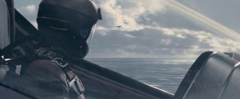 Movie still from “Stealth” (2005), directed by Rob Cohen – A person wearing a helmet is flying a kite; Wide shot, High angle