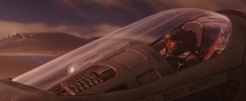 Movie still from “Stealth” (2005), directed by Rob Cohen – A man sitting inside of an airplane looking out of the window; Medium shot, Low angle