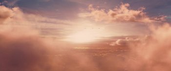 Movie still from “Stealth” (2005), directed by Rob Cohen – The sun is setting over the clouds in the sky; Extreme Wide shot, Low angle