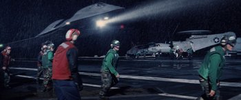 Movie still from “Stealth” (2005), directed by Rob Cohen – A man walking across a dock in the rain; Wide shot, High angle