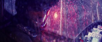 Movie still from “Stealth” (2005), directed by Rob Cohen – A person with a microphone in a car; Close Up shot, Low angle