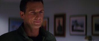 Movie still from “Stealth” (2005), directed by Rob Cohen – A person wearing a green jacket; Close Up shot, Over the shoulder angle