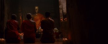 Movie still from “Stealth” (2005), directed by Rob Cohen – Two people sitting in front of a buddha statue; Wide shot, Low angle