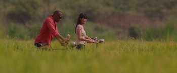Movie still from “Stealth” (2005), directed by Rob Cohen – A man and a woman in a field playing frisbee; Wide shot, Low angle