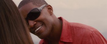 Movie still from “Stealth” (2005), directed by Rob Cohen – A person wearing a red shirt and sunglasses; Close Up shot, Low angle