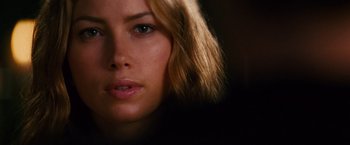 Movie still from “Stealth” (2005), directed by Rob Cohen – A woman's face in a dimly - lit room; Close Up shot, Over the shoulder angle