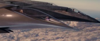 Movie still from “Stealth” (2005), directed by Rob Cohen – Two fighter jets flying in the sky above the clouds; Extreme Wide shot, Overhead angle
