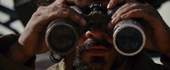 Movie still from “Stealth” (2005), directed by Rob Cohen – A person looking through binoculars; Extreme Close Up shot, High angle