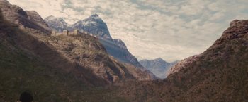 Movie still from “Stealth” (2005), directed by Rob Cohen – A mountain with a castle on top of a hill; Extreme Wide shot, High angle