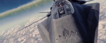 Movie still from “Stealth” (2005), directed by Rob Cohen – A fighter jet flying through the air over the clouds; Extreme Wide shot, Overhead angle