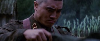 Movie still from “Stealth” (2005), directed by Rob Cohen – A man in a military uniform looking down; Close Up shot, Low angle