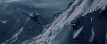 Movie still from “Stealth” (2005), directed by Rob Cohen – A man flying through the air while riding a snowboard; Extreme Wide shot, High angle