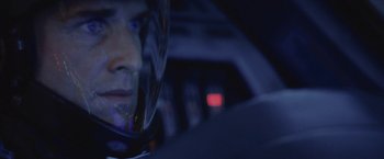 Movie still from “Stealth” (2005), directed by Rob Cohen – A man wearing a helmet sitting in a car at night; Close Up shot, Over the shoulder angle