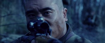 Movie still from “Stealth” (2005), directed by Rob Cohen – A person holding a gun; Extreme Close Up shot, Over the shoulder angle