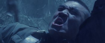 Movie still from “Stealth” (2005), directed by Rob Cohen – A man laying on the ground with his mouth wide open; Close Up shot, Low angle