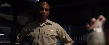 Movie still from “Stealth” (2005), directed by Rob Cohen – A man wearing a tan uniform with a pilot's badge on his chest; Medium shot, Low angle