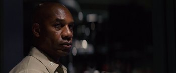 Movie still from “Stealth” (2005), directed by Rob Cohen – A man's face in a dark room; Close Up shot, Low angle