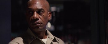 Movie still from “Stealth” (2005), directed by Rob Cohen – A man with a bald head is looking into the distance; Close Up shot, Low angle