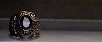 Movie still from “Stealth” (2005), directed by Rob Cohen – A gold ring with a blue stone on it; Extreme Close Up shot, High angle