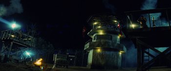 Movie still from “Stealth” (2005), directed by Rob Cohen – A truck parked in front of a building at night time; Extreme Wide shot, Low angle