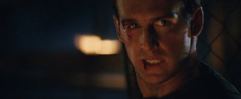 Movie still from “Stealth” (2005), directed by Rob Cohen – A person with a scar on his face; Close Up shot, Over the shoulder angle