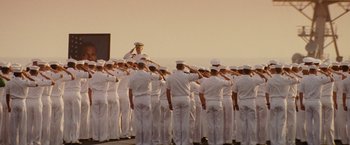 Movie still from “Stealth” (2005), directed by Rob Cohen – A group of sailors saluting in front of a crowd; Wide shot, Low angle