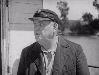 Movie still from “Steamboat Bill, Jr.” (1928), directed by Buster Keaton – An older man wearing a hat and a jacket; Close Up shot, Low angle