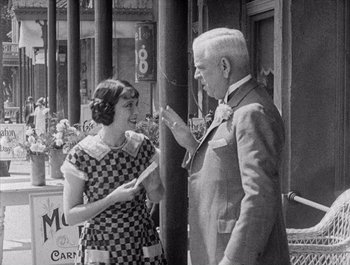 Movie still from “Steamboat Bill, Jr.” (1928), directed by Buster Keaton – An older man and a young woman are talking to each other; Medium shot, Over the shoulder angle