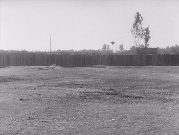 Movie still from “Steamboat Bill, Jr.” (1928), directed by Buster Keaton – An empty field with a fence in the background; Extreme Wide shot, Low angle
