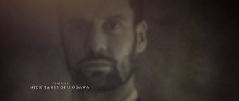 Movie still from “Still” (2018), directed by Takashi Doscher – A man's face in a black and white photo; Extreme Close Up shot, Low angle