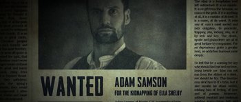 Movie still from “Still” (2018), directed by Takashi Doscher – A wanted poster of a man with a beard; Medium shot, Low angle