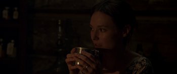 Movie still from “Still” (2018), directed by Takashi Doscher – A woman is holding a cup in her hands; Close Up shot, Over the shoulder angle
