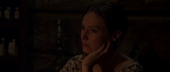 Movie still from “Still” (2018), directed by Takashi Doscher – A woman is sitting in the dark with her hand on her chin; Close Up shot, Over the shoulder angle