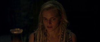 Movie still from “Still” (2018), directed by Takashi Doscher – A woman with long blonde hair is looking at the camera; Close Up shot, Over the shoulder angle