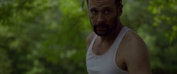 Movie still from “Still” (2018), directed by Takashi Doscher – A person wearing a tank top; Close Up shot, Low angle