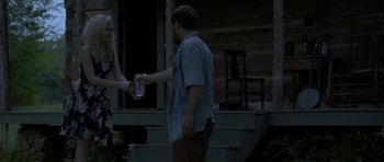 Movie still from “Still” (2018), directed by Takashi Doscher – A man and a woman are holding a can of beer; Medium shot, Over the shoulder angle