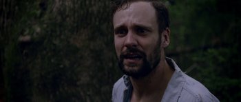 Movie still from “Still” (2018), directed by Takashi Doscher – A person with a beard; Close Up shot, Over the shoulder angle