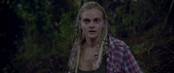 Movie still from “Still” (2018), directed by Takashi Doscher – A person with dreads wearing a plaid shirt; Close Up shot, Over the shoulder angle