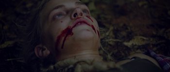 Movie still from “Still” (2018), directed by Takashi Doscher – The face of a child with blood on his face; Close Up shot, Overhead angle