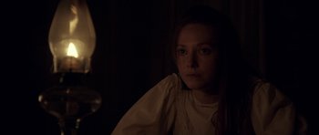 Movie still from “Still” (2018), directed by Takashi Doscher – A woman in a white shirt is looking at the camera; Close Up shot, Over the shoulder angle