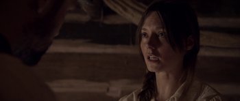 Movie still from “Still” (2018), directed by Takashi Doscher – A young woman in a white shirt is looking at the camera; Close Up shot, Over the shoulder angle