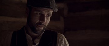 Movie still from “Still” (2018), directed by Takashi Doscher – A person wearing a hat; Close Up shot, Over the shoulder angle