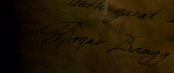 Movie still from “Still” (2018), directed by Takashi Doscher – Picture of the signature of a person; Extreme Close Up shot, Overhead angle