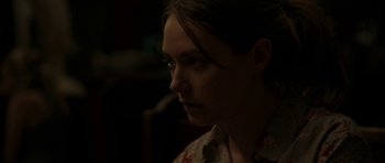 Movie still from “Still” (2018), directed by Takashi Doscher – A woman is looking into the distance in the dark; Close Up shot, Over the shoulder angle