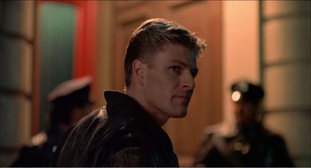 Movie still from “Stormy Monday” (1988), directed by Mike Figgis – A person wearing a leather jacket; Close Up shot, Low angle