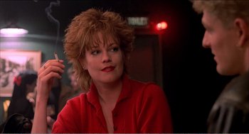 Movie still from “Stormy Monday” (1988), directed by Mike Figgis – A person wearing a red shirt; Close Up shot, Low angle