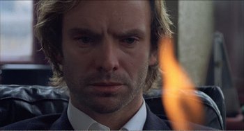 Movie still from “Stormy Monday” (1988), directed by Mike Figgis – A person wearing a suit and a tie; Close Up shot, Low angle