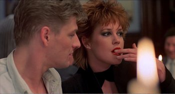 Movie still from “Stormy Monday” (1988), directed by Mike Figgis – A man and a woman sitting next to each other; Close Up shot, Over the shoulder angle
