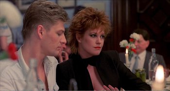 Movie still from “Stormy Monday” (1988), directed by Mike Figgis – A man and a woman sitting in front of a table; Close Up shot, Low angle
