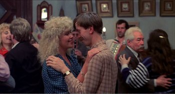 Movie still from “Stormy Monday” (1988), directed by Mike Figgis – A man and a woman dancing in front of a crowd; Medium shot, Over the shoulder angle